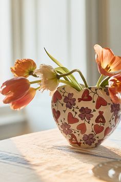 a vase filled with flowers on top of a table