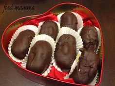 chocolates in a heart shaped box on a table