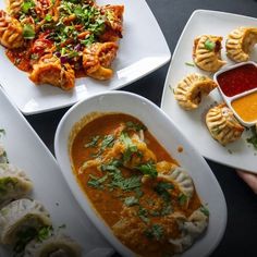 several plates of food on a table with dipping sauces