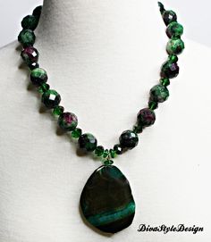 Faceted Ruby Zoisite Necklace designed with Faceted Crystals and a Beautiful Malachite Gemstone Pendant. The combinations of Ruby Zoisite and Malachite is a stunning statement necklace. SUPERIOR CONSTRUCTION: * All jewelry is strung on sturdy nylon-coated professional jewelry wire, leather cord, or chain and is finished with wire guards wire protectors, memory wire, or heavy-duty stretch beading thread. MATERIALS: When using natural stones, no two stones look alike so if duplicates are designed, Green Chrysocolla Gemstone Beads Jewelry, Green Agate Jewelry With Faceted Beads, Green Chrysocolla Necklaces With Natural Stones, Green Chrysocolla Gemstone Jewelry, Green Agate Gemstone Crystal Necklace, Green Agate Gemstones With Beads, Green Agate Gemstone Beads, Green Natural Stones For Jewelry Making, Green Spiritual Necklace With Gemstone Accents