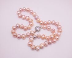 This gorgeous light peach freshwater pearl necklace is perfect for that loved one.  Hand knotted with care on silk thread with an elegant rhodium plated box clasp with cubic zirconia.  Details: Pearl Size: around 10 mm x 7mm Length: 18 inches Clasp: Rhodium Plated with Cubic Zirconia Elegant Pink Pearl Necklace For Anniversary, Pink Pearl Drop Necklace For Formal Occasions, Pear-shaped Single Strand Pearl Necklace For Wedding, Single Strand Pear-shaped Pearl Necklace For Wedding, Formal Pink Pearl Drop Necklace, Pink Pearl Drop Necklace, Pink Pearl Charm Necklace For Wedding, Formal Pink Round Pearl Necklace, Formal Pink Pearl Necklace With Pearl Charm