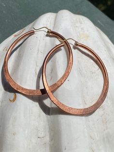 Thick Gauge Hammered Hoops  Solid Copper Earrings  Made to order  2week  turn around  Handwrought Comfy weight with movable parts 2.5 inches Length by 2.5 inches Width  100% Handcrafted  Made with love *PLEASE NOTE BRASS AND COPPER NATURALLY PATINAS OVER TIME. Research what patina means as well as how to clean/ shine and store to gain better innerstand of organic materials. Hammered Copper Hoop Jewelry, Artisan Gold Hoop Earrings In Copper, Handmade Copper Round Hoop Earrings, Hammered Copper Earrings Rustica Jewelry, Artisan Copper Hoop Earrings, Pierced, Hammered Copper Earrings, Hammered Copper, Copper Earrings, Copper Jewelry