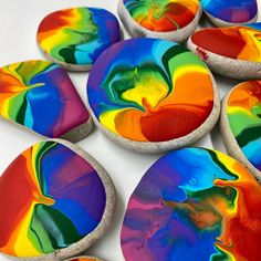 colorful painted rocks sitting on top of a white table