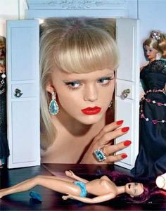 two mannequins are next to each other in front of a dress and jewelry display