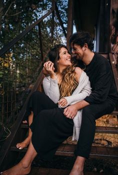 a man and woman sitting on the steps together