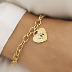 Introducing our Heart Gold Plated Initial Charm Bracelet--a stunning blend of elegance and personal touch. This sophisticated piece is expertly designed with a beautiful heart charm, measuring 20mm x 20mm, and is crafted from high-quality 18K gold plated stainless steel. Its timeless appeal and durability make it a perfect accessory for any occasion. Our bracelet is not just about style; it's built to last. The waterproof and hypoallergenic properties ensure it's suitable for daily wear, whether Classic Gold Charm Bracelet With Heart, Personalized Gold-tone Bracelets As A Gift, Gold Heart-shaped Stainless Steel Bracelet, Gold Stainless Steel Bracelets For Valentine's Day, Gold-tone Charm Bracelet As Gift, Elegant Engraved Heart Charm Bracelet, Gold Heart Bracelet With Charms For Mother's Day, Elegant Stainless Steel Chain Bracelet For Valentine's Day, Mother's Day Gold Heart Bracelet With Charms