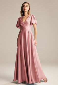 a woman in a long pink dress with flutter sleeves and a v - neckline