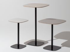 three black and white tables with one table on the other, all in different positions