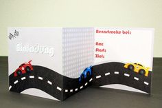 an opened card with cars driving on a road and the words endecking written in german