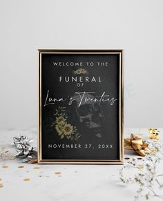 a black and gold wedding welcome sign with flowers