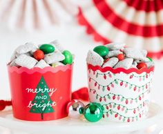 two red and white christmas cups filled with candy