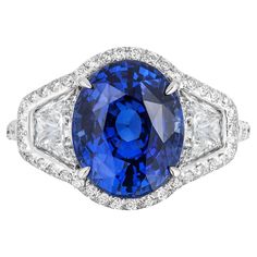 A platinum ring featuring a large Blue Sapphire accompanied by two diamonds (1.12 carats total), beautifully adjoined by a halo and band that together feature 64 sparkling micro-diamonds. Details Center: Blue Sapphire – 6.22ct Dimensions : 11.36 x 9.24 x 7.06 mm Side: 2 Diamonds – 1.12 ct total. Halo & Band: Micro-Diamonds – 0.1 ct total Quality grade : Very Good Color: Blue Shape/style : Oval/ Mixed Cut Transparency : Transparent Ring: Platinum Ring CD Certified Sapphire Oval Ring, Halo Band, Oval Ring, Oval Rings, Platinum Ring, Three Stone Rings, Three Stone, Blue Sapphire, Amazing Women