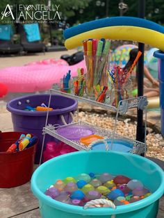 several buckets filled with different colored toys