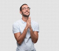 a man in glasses is praying with his hands together and looking up to the sky