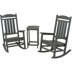 three black rocking chairs and table on a white background