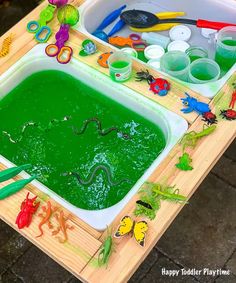 a wooden table topped with lots of green liquid