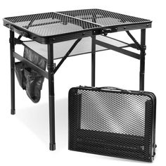 two pieces of luggage sitting on top of a black metal table with mesh coverings