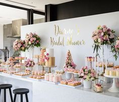 a table filled with lots of cakes and cupcakes on top of white tables