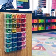 there are many different colored glasses on the shelf in this store, and it looks like they have been made out of plastic