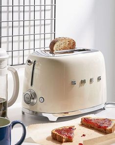 two slices of toaster bread sitting on top of a counter next to a cup