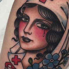 a close up of a tattoo with a woman's face and cross on it