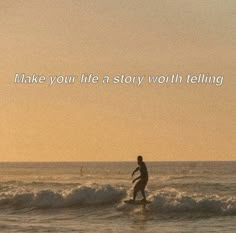 a man riding a surfboard on top of a wave in the ocean at sunset