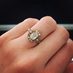 a person's hand with a ring on it