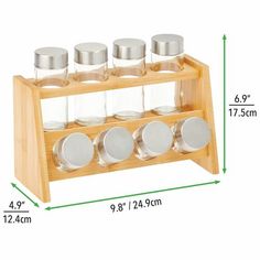 a wooden spice rack with six glass jars on it and measurements for the top one