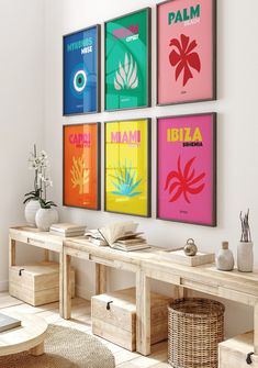 four colorful posters hang on the wall above a table