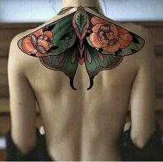 the back of a woman's body with tattoos on her upper and lower back