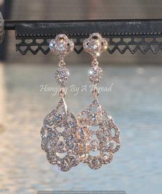 "Amazing new earrings made using rose gold and premium rhinestones. The earrings are filigree style, and feature paved crystal clear stones. The earrings have a post located at the back of the top link. Earrings are lightly rose gold plated, so are a lovely shade of muted rose gold. Earrings measure 3 1/4\" long. They come with over sized, disc ear nuts to help hold them firm on your ears. Stunning and classic, perfect for any bride or special occasion! ** These are large and have lots of crysta Rose Gold Crystal Chandelier Earrings For Party, Elegant Rose Gold Crystal Chandelier Earrings, Rose Gold Crystal Drop Bridal Earrings, Sparkling Rose Gold Crystal Earrings For Wedding, Rose Gold Crystal Rhinestone Earrings, Rose Gold Rhinestone Crystal Earrings, Sparkling Rose Gold Crystal Wedding Earrings, Rose Gold Crystal Chandelier Drop Earrings, Rose Gold Crystal Chandelier Earrings