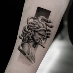 a black and white photo of a woman's head with snakes on her arm