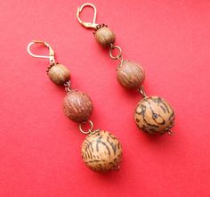 Super long earrings have comfortable for wearing due to their lightweight - 10 g/0.4 oz. Material - natural wooden beads and nickel-free goldish lock. Dimensions:  3 inches long (measured from the top of ear wire to bottom of the earring)    Wooden balls earrings are equally stunning look adorable with bare shoulders or all of your fantastic scarves.  They add a boho-chic touch to any outfit all over the year. The largest bead has runic symbols burned by hand. Runic Symbols, Wooden Bead Earrings, Natural Essence, Blue Statement Necklace, Black Bead Necklace, Beads Earrings, Bare Shoulders, Wooden Earrings, Wooden Jewelry