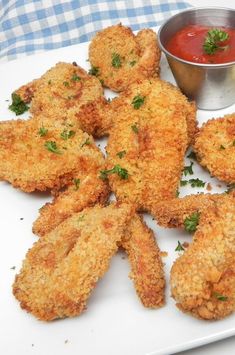 two pieces of fried chicken on a plate with broccoli