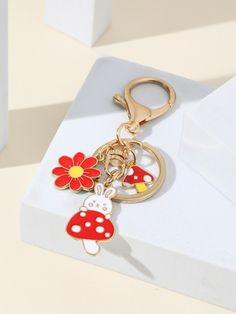 a red and white mushroom keychain sitting on top of a box