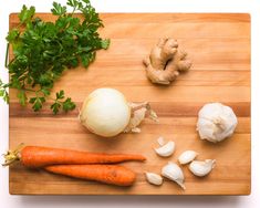 carrots, garlic and parsley on a cutting board