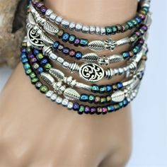 "Fun and festive this seven layer bracelet is sure to make a fresh statement. The layered silver and colored beads give that fun boho vibe which will compliment nearly all outfits, and is perfect for everyday, beach vacations, or special occasions. The one-size-fits-all feature makes this a great gift for any woman. Made with memory wire, a kind of wire that never loses its shape. You simply wrap the bracelet around your wrist. The bracelet coils wrap around the wrist and gives the impression of Festival Multicolor Bracelets With Silver Beads, Multicolor Silver Beaded Bracelets For Festivals, Multicolor Silver Beads Bracelets For Festival, Bohemian Silver Wrap Bracelet, Nickel Free, Silver Bohemian Wrap Bracelet Nickel Free, Nickel Free Silver Bohemian Wrap Bracelet, Adjustable Silver Bohemian Wrap Bracelet, Nickel-free Silver Bohemian Wrap Bracelet, Bohemian Nickel-free Silver Wrap Bracelet