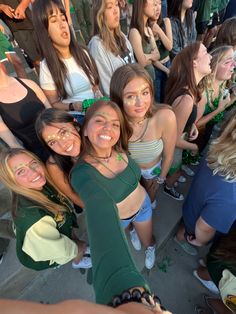 a group of young women standing next to each other in front of a crowd at a sporting event