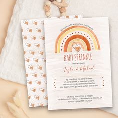 a baby sprinkle is on top of a card next to a teddy bear