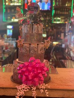 there is a cake that has been made to look like a tower with pink bows on it