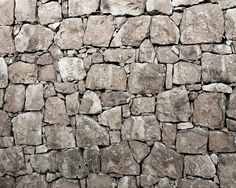 an old stone wall made out of small rocks