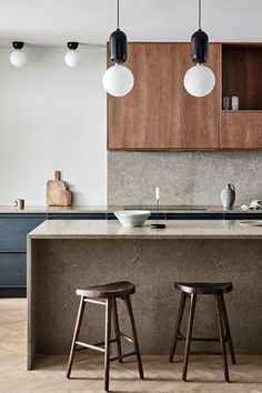 two stools sit in front of an island counter