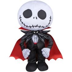 a stuffed toy that is wearing a suit and tie with a skull on it's chest