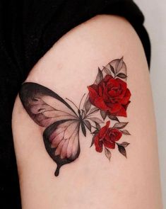 a woman's arm with a butterfly and roses tattoo on it