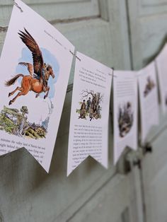 some cards are hanging from a clothes line with pictures of horses and people on them