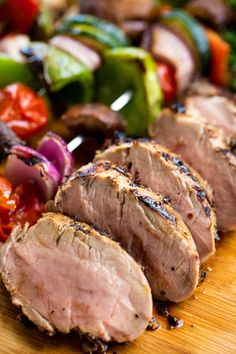 sliced meat and vegetables on a cutting board