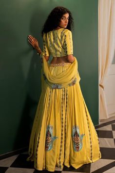 Yellow kali lehenga with evil eye print buttas, embellished waistline and attached cancan. Paired with a padded blouse and a chiffon dupatta.
Components: 3
Pattern: Embroidered
Type Of Work: Cutdana, Bead
Neckline: V Neck
Sleeve Type: Short
Fabric: Muslin
Color: Yellow
Other Details: 
Attached lining
Closure:
Lehenga: Button
Occasion: Mehendi and Haldi - Aza Fashions Navratri Lehenga With Tilla Embroidery, Tilla Lehenga For Navratri, Yellow Tilla Sets For Diwali, Traditional Yellow Lehenga With Tilla, Yellow Lehenga For Transitional Party, Yellow Lehenga With Tilla For Navratri, Yellow Lehenga For Transitional Party Season, Yellow Lehenga For Party And Transitional Seasons, Anarkali Floor-length Sharara With Tilla Details