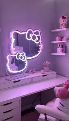 a pink hello kitty mirror sitting on top of a desk next to a white chair