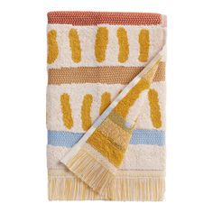 a yellow and blue towel with a brush on it's side, against a white background