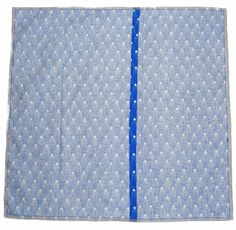 a piece of fabric with blue stitching on the side and white dots in the middle